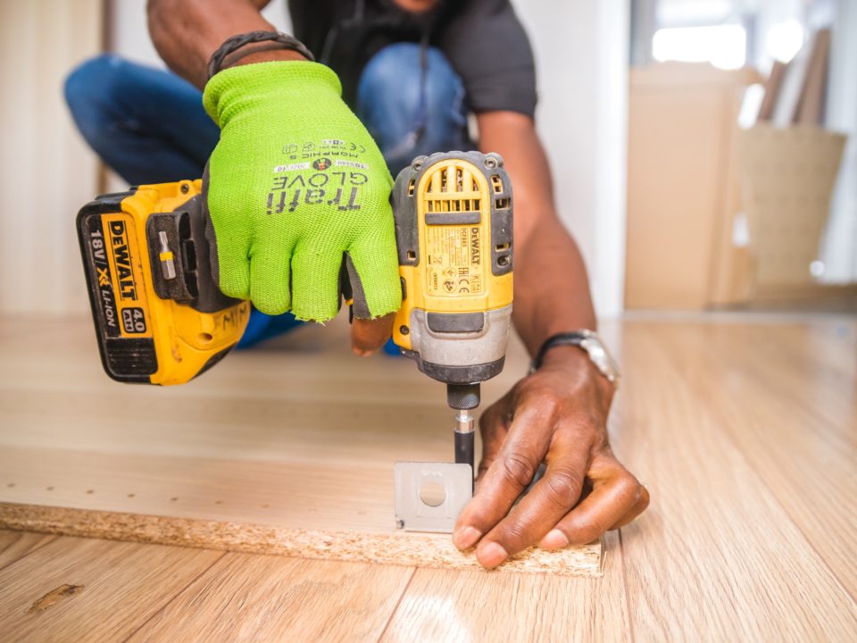 close up photo of hands holding a drill